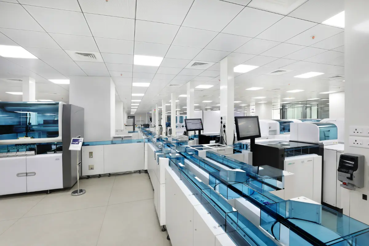 Pathology laboratory technician using precision microscopy to search for malaria parasites in a blood smear